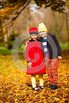 Friends play in a beautiful autumn park together