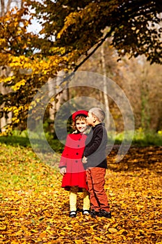 Friends play in a beautiful autumn park together