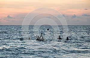 Friends Playing Ball in Ocean at Dusk