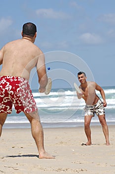 Friends playing beach tennis