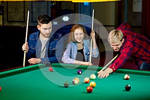 Friends playing billiard