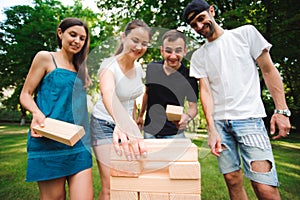 Friends playing board game outdoors in the park.