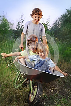 friends playing in the plane using a garden carts