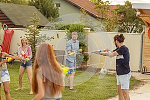 Friends playing with squirt guns