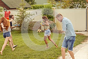 Friends playing with squirt guns