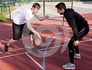 Friends playing street basketball