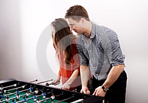 Friends playing table football.