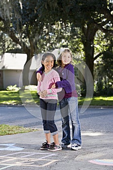 Friends playing together on driveway