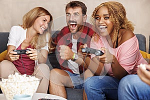 Friends playing video games and having fun at home