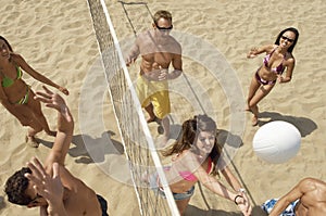 Friends Playing Volleyball On Beach