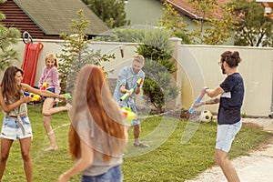 Friends playing with water guns