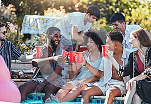 Friends, pool party and cheers on summer vacation with happy people drinking and laughing with feet in water. Friendship