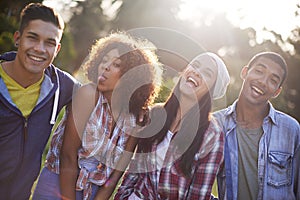 Friends, portrait and smile in nature for adventure, vacation and weekend break in outdoors. Happiness, lens flare and