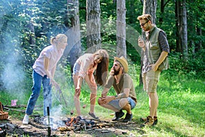 Friends prepare roasted sausages snacks nature background. Camping traditional meal prepared on fire with smoky aroma