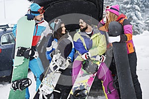 Friends prepare for snowboarding photo