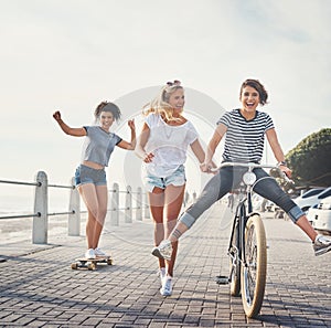 Friends put the f in fun. Shot of three friends having fun on the promenade.