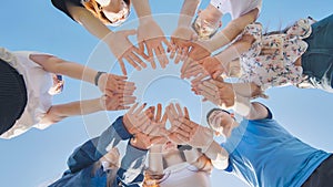 Friends putting their hands together in a sign of unity and teamwork. Just the hands.