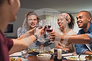 Friends raising toast during dinner