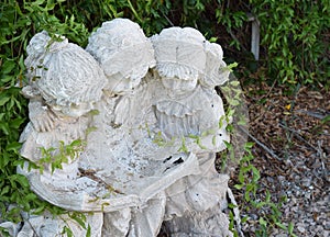 Friends reading outside statue in yard