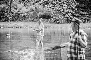 Friends relationship. mature man fisher. hobby and sport activity. son and father fishing. male friendship. family