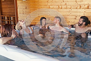 Friends relaxing in a hot tub while on a vacation