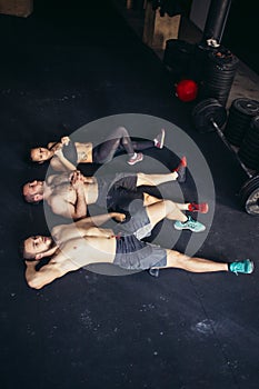 Friends relaxing and taking a break after working out at a cross-training gym