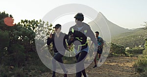 Friends, running and trail outdoor on mountain in nature, race and fitness with travel and adventure by trees. People
