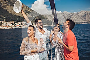 Friends sailing on yacht. Vacation, travel, sea, friendship and people concept