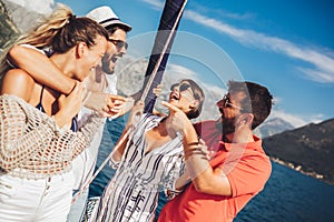 Friends sailing on yacht. Vacation, travel, sea, friendship and people concept