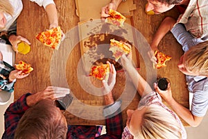 Friends sharing a pizza together, overhead view