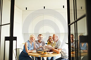 Friends Sharing Stories at Kitchen Table