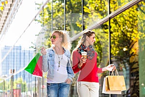 Friends with shopping bags in street