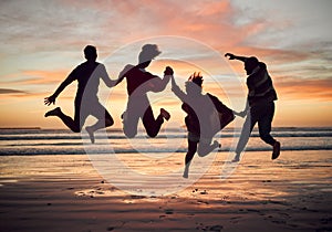 Friends, silhouette and jump on the beach during sunset on vacation together. Excited people on travel holiday in summer