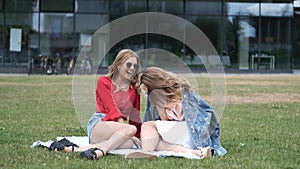 Friends sitting on blanket next to university
