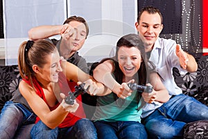 Friends sitting in front of game console box