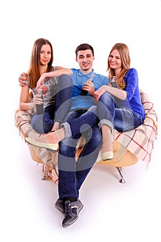 friends sitting on a sofa and drinking soda