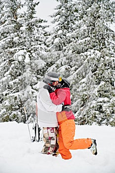 Friends skiers having fun at ski resort in the mountains in winter, skiing and snowboarding