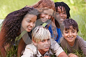 Friends, smile and group of children in field together for summer camp, adventure or outdoor fun. Diversity, grass and