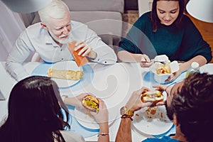 Friends smiling at the diner in the house