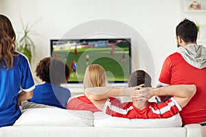 Friends or soccer fans watching game on tv at home