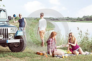 Friends spending time near lake