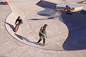 Friends, sports and men with skateboard, ramp or bowl action at a skate park for stunt training. Freedom, adrenaline and