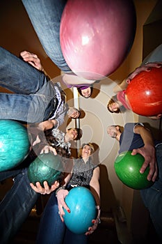 Friends stand in circle and everybody hold ball photo