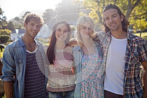 Friends standing together in park