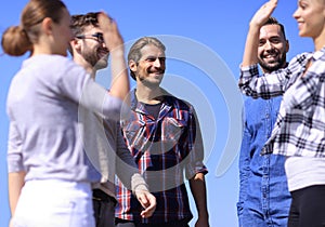 Friends students giving each other a high five.