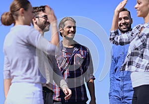 Friends students giving each other a high five.