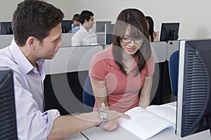 Friends Studying Together In Computer Lab