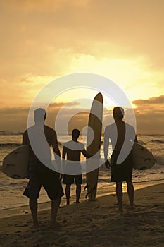 Friends With Surfboard Watching Sunset At Beach