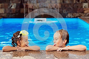 Friends swimming in outdoor pool and having fun together. Family vacation and tourism concept