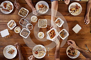 Friends at a table sharing Chinese take-away, overhead view